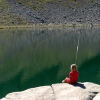 Fishing in Val di Fiemme - Girl fishing in a mountain lake in Val di Fiemme
