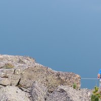 Climber suspended on Cermiskyline - Picture of a suspended climber on the lakes ferrata in val di Fiemme
